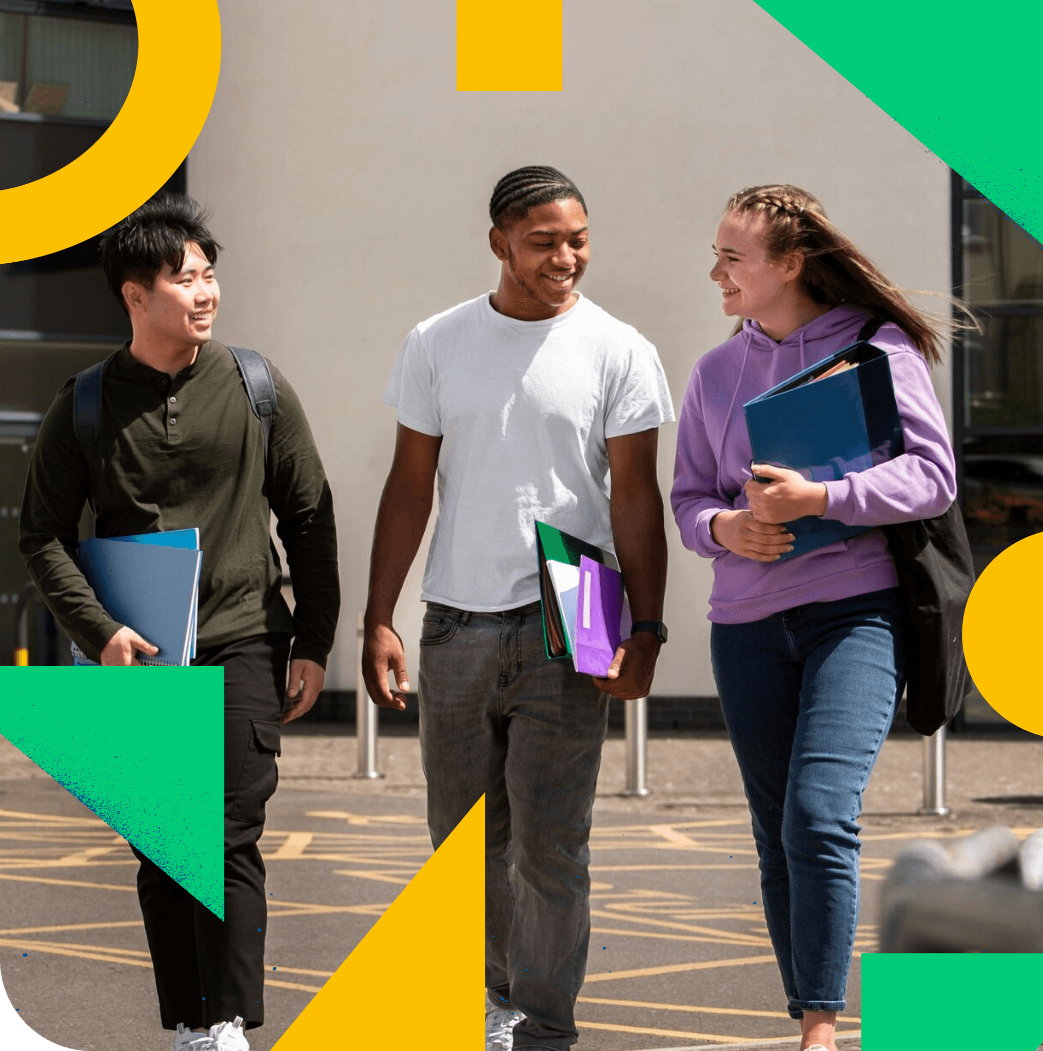 Three students walking and talking with notebooks in hand.